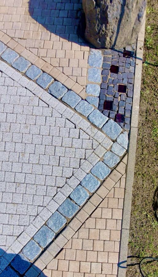 Derselbe Gehwegabschnitt am Europaweg nach der Reinigung mit klar erkennbaren Pflasterelementen, am Europaweg in Staudt